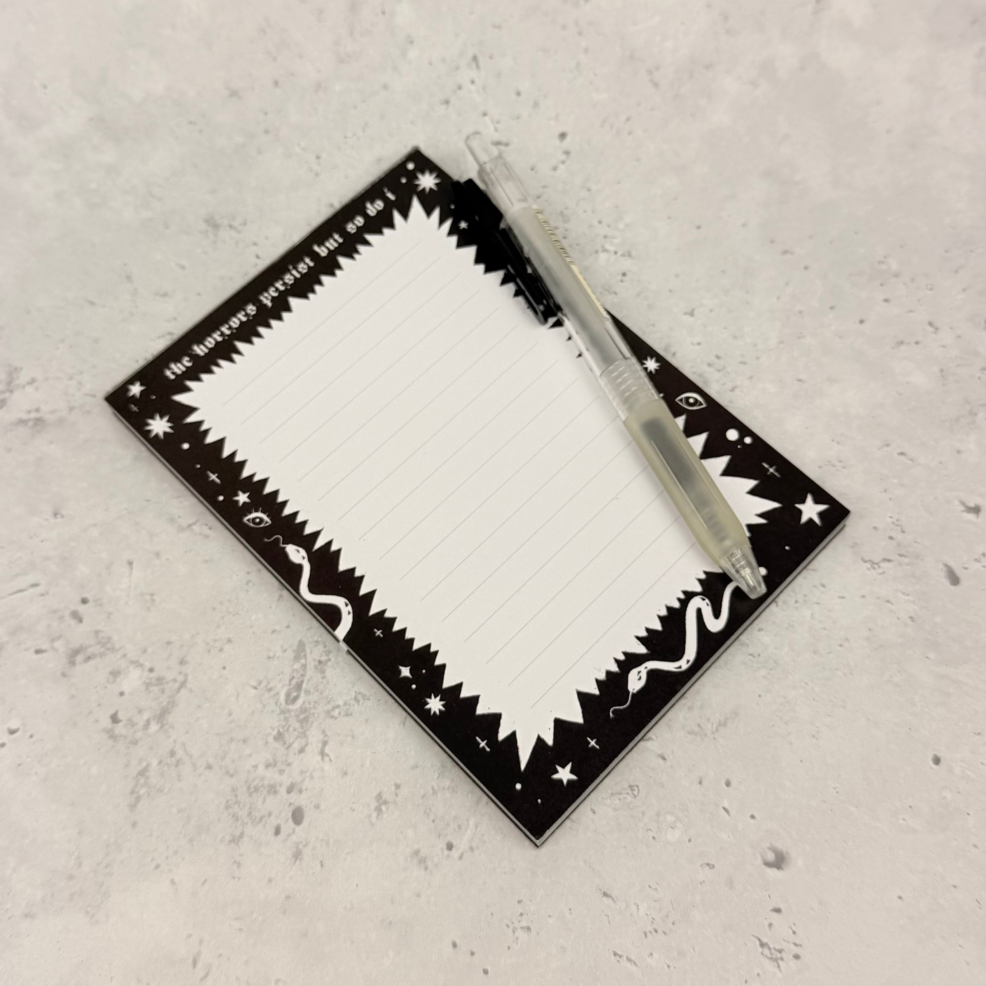 Rectangular white plate with black decorative border on a gray surface