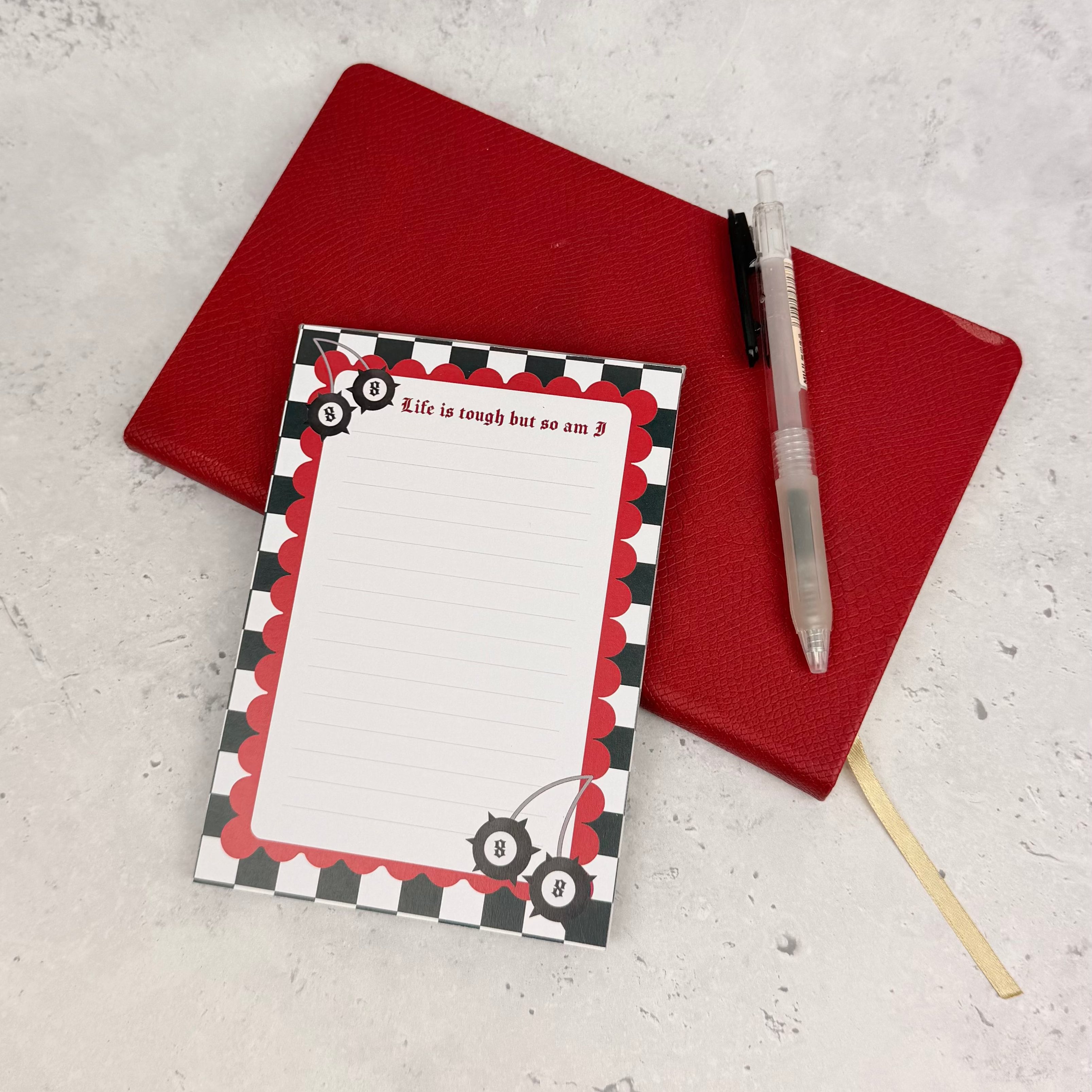 Notepad with a decorative cover on a red background